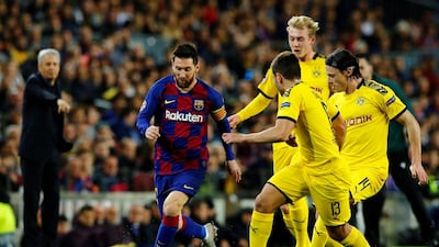 Borussia Dortmund players attempt to stop Barcelona attacker Lionel Messi. EPA
