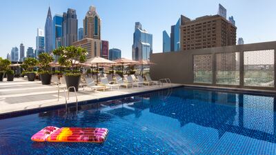 The outdoor pool comes with city skyline views.