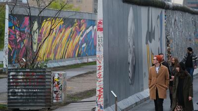 Visitors walk along a still-standing section of the former Berlin Wall called the East Side Gallery in Berlin, Germany. Getty Images