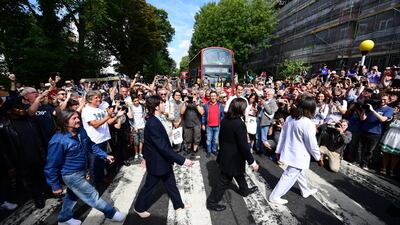 Beatles impersonators recreate the iconic 'Abbey Road' photograph made 50 years ago today, on August 8