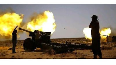 Anti-Qaddafi fighters fire heavy artillery near Sirte yesterday. Goran Tomasevic / Reuters