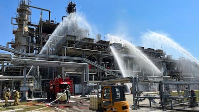 Emergency workers put out a fire caused by a strike on the Novoshakhtinsk oil refinery in Russia, a few months after Moscow invaded Ukraine. AP