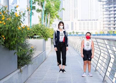 Triathlete Afra Al Majar, right, with Asma Al Janahi by Dubai Canal. Reem Mohammed / The National