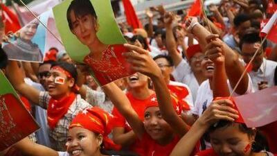 Supporters of Aung San Suu Kyi's the National League for Democracy party cheer as they learn the preliminary results of Sunday's vote.