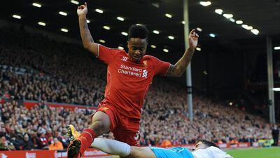 Liverpool's Raheem Sterling leaps after the ball as he's tackled by Hull City's Alex Bruce in their Premier League draw on Saturday. Peter Powell / EPA