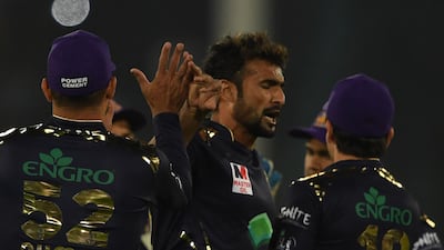 Quetta Gladiators' Sohail Khan, centre, celebrates with team mates after taking the wicket of Islamabad United's Luke Ronchi. AFP