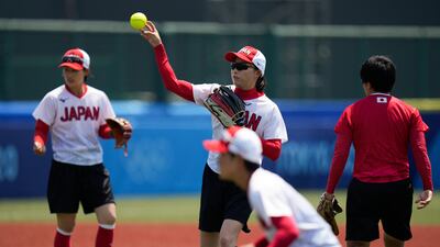 Members of the Japanese women's softball team train at the Fukushima Azuma Baseball Stadium.