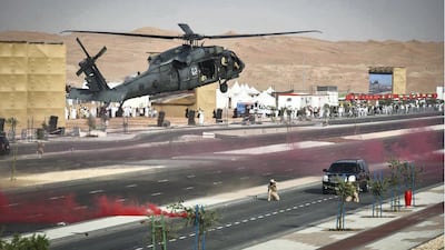 A helicopter provides cover for ground forces below. Wam