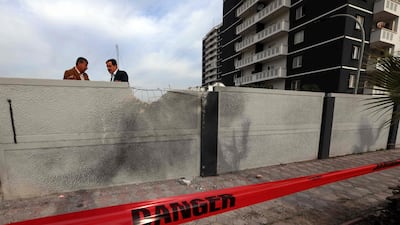 Two men stand near the scene of a rocket attack targeting Erbil's airport, the first time in nearly two months that Western military or diplomatic installations have been targeted in Iraq. AFP