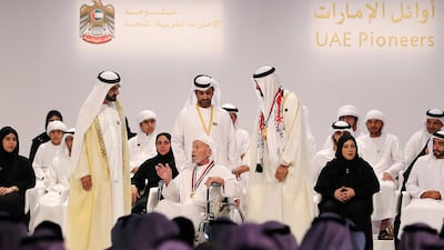 Sheikh Mohammed bin Rashid, Vice President and Ruler of the Dubai, and Sheikh Mohammed bin Zayed, Crown Prince of Abu Dhabi and Deputy Supreme Commander of the Armed Forces, honour Saif Al Mansoori with a UAE Pioneer Award for a lifetime of charitable work. Pawan Singh / The National