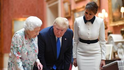 Britain's Queen Elizabeth II (L) views a display of US items of the Royal collection with US President Donald Trump and US First Lady Melania Trump at Buckingham Palace. AFP