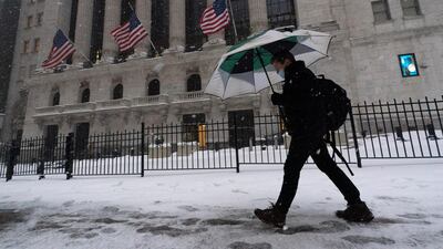 A man walks past the New York Stock Exchange. Stronger corporate earnings are expected to have a positive impact on US equity markets. Photo: AP
