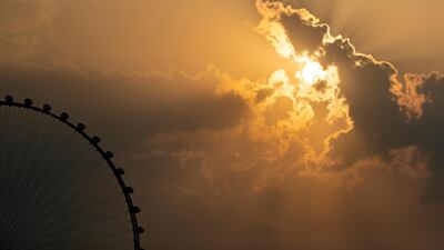 The sun sets behind the Ain Dubai big wheel after the rain came down in Dubai on November 8. All pictures by Chris Whiteoak / The National