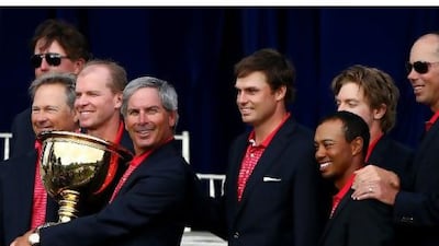 Fred Couples, holding the trophy, and his American team pose with the Presidents Cup in Melbourne, Australia, yesterday. Ryan Pierse / Getty Images