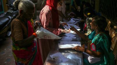 Voters present their documents at a polling station in Chennai, Tamil Nadu. Bloomberg