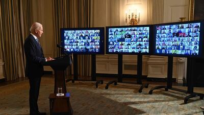 US President Joe Biden swears in presidential appointees during a virtual ceremony in the State Dining Room of the White House in Washington. AFP