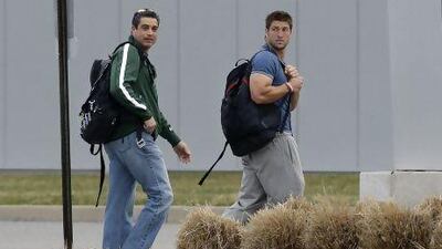 New York Jets quarterback and now free agent, Tim Tebow, right, walks away with the Jets assistant coach, Louis Aguiar. Mel Evans / AP Photo