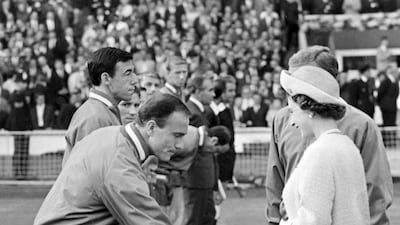Britain's Queen Elizabeth II shakes hands with England defender George Cohen before the start of the 1996 World Cup against Uruguay ay Wembley Stadium, London, on July 11, 1966. AP