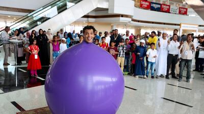 Visitors are entertained by performance artists at the Dubai World Cup. Chris Whiteoak / The National