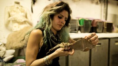 Nora Lifschitz treats a wounded Egyptian fruit bat in her apartment in Tel Aviv before the sanctuary was set up. EPA