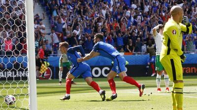 Antoine Griezmann celebrates with teammate Olivier Giroud after scoring France’s second goal. Thibault Camus / AP Photo