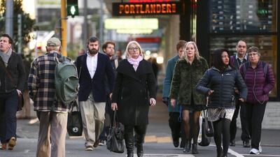 People make their way into the CBD during the first day under COVID-19 Alert Level 1 in Wellington, New Zealand. Getty Images