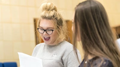 Bethan Davis, left, and Imogen Hughes, both 16, look over their GCSE results at the British School Al Khubairat in Abu Dhabi. Christopher Pike / The National