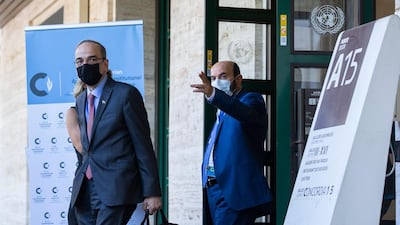 Hadi Al Bahra, left, co-chairman of the Syrian Constitutional Committee, leaves the UN headquarters in Geneva, Switzerland, on Monday, August 24, 2020. AP