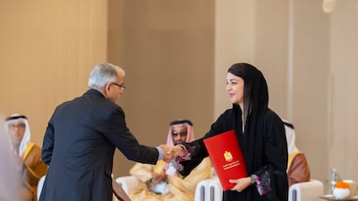 Reem Al Hashimy, Minister of State for International Co-operation, exchanges a document of agreement between India and the UAE, relating to the Bilateral Investment Treaty. Ryan Carter / Presidential Court
