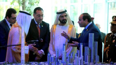 Egyptian President Abdel Fattah El Sisi and Sheikh Mohammed bin Rashid, Vice President and Ruler of Dubai, listen to Egyptian investment minister Ashraf Salman (3rdR) as they look at a scale model of the new Egyptian capital Cairo displayed at the congress hall in the Red Sea resort of Sharm el-Sheikh, in March 2015. AFP