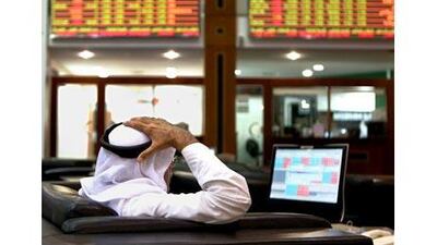An investor monitors trading at the Dubai Financial Market. The index declined 4.6 per cent. Paulo Vecina / The National