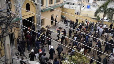Pakistani security officials inspect the scene of the attack. EPA