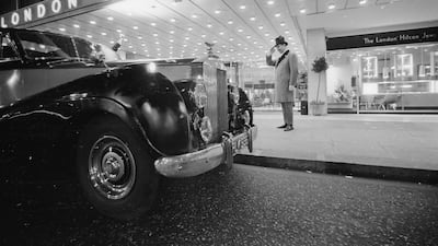 A doorman salutes a guest arriving at the Hilton Hotel, London, in a Rolls Royce in 1965.