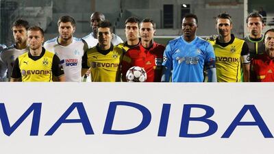 Borussia Dortmund and Marseille lined up before their Champions League match on Wednesday with a Mandela tribute sign. Sebastian Nogier / EPA