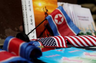 North Korean and American flags and books are displayed for sale at a stall outside the St. Regis hotel, where North Korean leader Kim Jong Un is staying in Singapore. SeongJoon Cho / Bloomberg