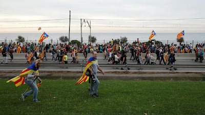 Catalan demonstrators wearing and waving Esteladas (Catalan separatist flags) chant slogans as they march during Catalonia's general strike in El Masnou, Spain, October 18, 2019. REUTERS/Albert Gea