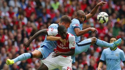 Manchester City’s Fernando, right, and teammate Matija Nastasic challenge Arsenal’s Yaya Sanogo during their English Community Shield soccer match at Wembley Stadium in London, August 10, 2014. REUTERS/Suzanne Plunkett
