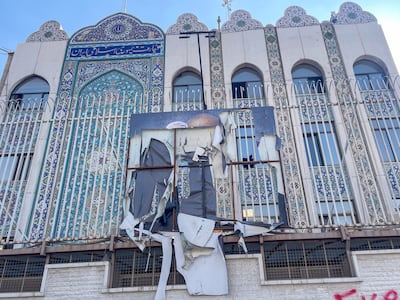 A torn poster of Qassem Suleimani, former leader of Iran's Islamic Revolutionary Guard Corps' Quds Force, at the entrance of the Iranian embassy in Damascus. Matt Kynaston / The National