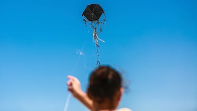 A Palestinian child flies a kite in a displacement camp in Gaza City on July 29. Middle East Images via AFP
