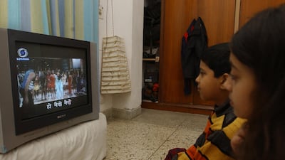 Children watch 'Rangoli' with Hindi subtitles in an experiment that took place in India back in 2002 to 2007. AFP