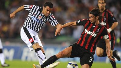 Udinese’s forward Fabio Quagliarella fights for the ball with Paolo Maldini of AC Milan during their Serie A football match on May 16, 2009 in Udine. AFP PHOTO / ANTEPRIMA