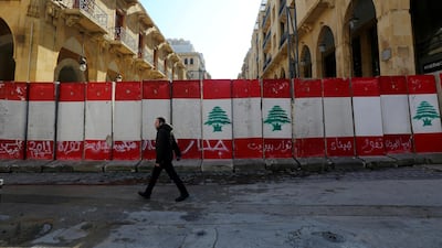 A man walks past concrete barriers near parliament in Beirut. Reuters