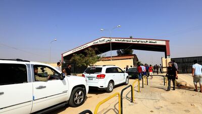 Vehicles cross from Jordan to Syria through the Jaber-Nassib border crossing after it was reopened between Syria and Jordan. EPA
