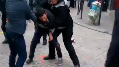 A man identified as Alexandre Benalla, right, confronts a student during a May Day demonstration in Paris. Nicolas Lescaut via AP
