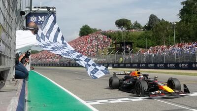 Red Bull driver Max Verstappen takes the chequered flag to win the race. AP