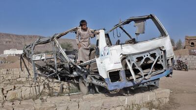 A Yemeni child stands in the wreckage of a bus that was hit by a Saudi-led coalition air strike on the Dahyan market in August. AFP