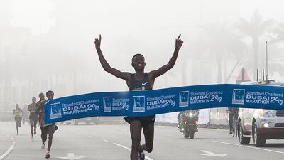 Elite runner Lilisa Desisa Benti of Ethiopia crosses the finish line to win the Standard Chartered Dubai Marathon today.