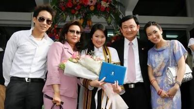 Ousted Thai prime minister Thaksin Shinawatra (second from right), who was deposed in a bloodless 2006 coup, poses for a family photo at daughter Paetongtarn’s graduation from a Bangkok university.