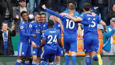 Jamie Vardy, second left, is swamped by teammates after scoring his first and Leicester City's second goal against Arsenal. Reuters