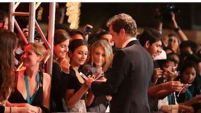 The actor Colin Firth with fans on DIFF opening night at the Madinat Arena. As well as plenty of Hollywood glamour, there are 70 Arab films showing in the festival this year.